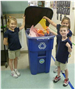 Three children recycling construction paper