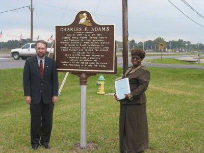 Carolyn Brown standing with the historical marker