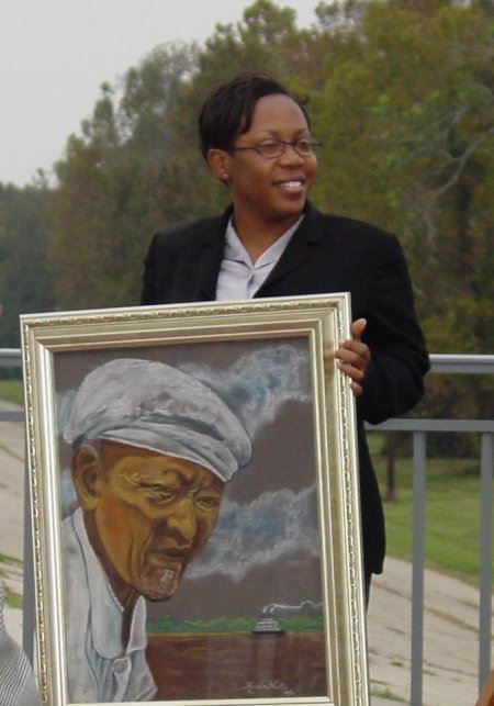 Keisha West holding a painting of her great uncle