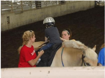 Child riding a horse
