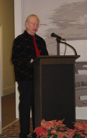 Woman speaking at a podium during dedication