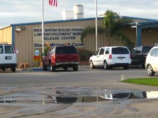 Cars parked in a parking lot in front of a commercial building